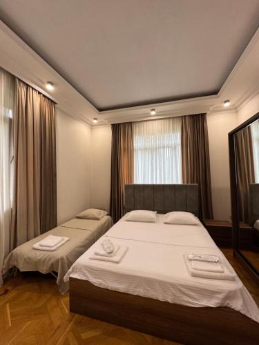 a bedroom with two beds with towels on them at Green villa panorama in Batumi