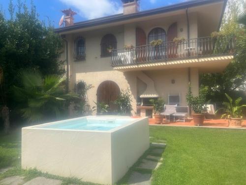 a house with a swimming pool in front of it at federica guest house in Forte dei Marmi