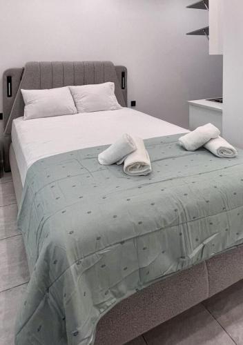 a large bed with two towels on top of it at Hera Luxury Suite by Zeus Suites in Athens