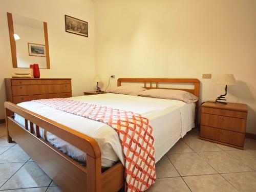 a bedroom with a large bed and two night stands at Terrazza Su Crosio a Clusone in centro! in Clusone