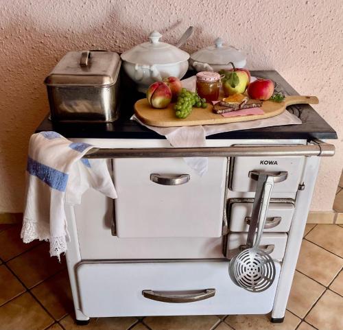 a counter with a tray of fruits and vegetables on it at Landurlaub bei Familie Haug in Freyung