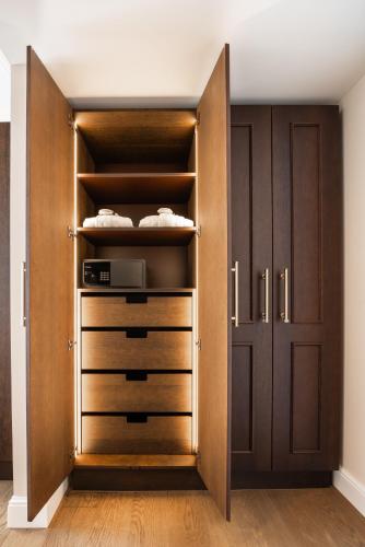 a closet with wooden doors and drawers at Grand Hotel National Luzern in Luzern