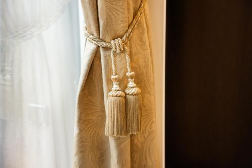 a rope tied to a window with a curtain at Grand Hotel National Luzern in Luzern