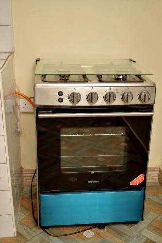 a stove in a kitchen with a stove top at Aida's Gardens And Mable's Kitchen Entebbe in Entebbe