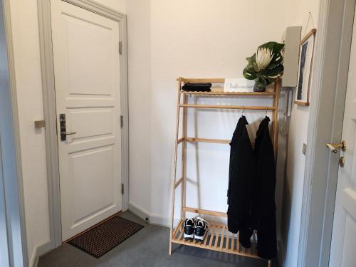 a hallway with a shelf next to a door at aday - Vejle City Center 1 Bedroom Apartment in Vejle