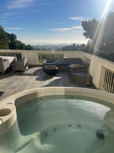 a large swimming pool on a patio with a patio furniture at Big Bright Burlingame Hills Bay View Home in Burlingame