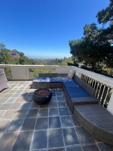 a patio with a couch and a fire pit at Big Bright Burlingame Hills Bay View Home in Burlingame