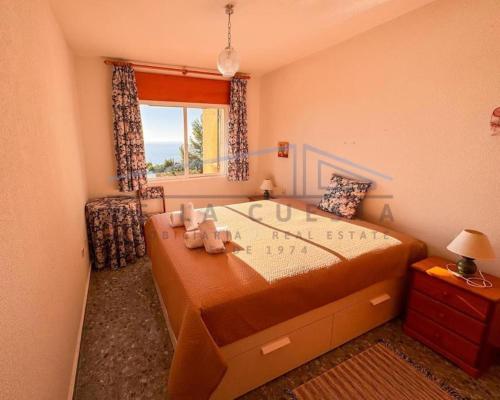 a bedroom with a large bed with a window at Villa Marietta, private pool villa with sea views and terrace, perfect for families and remote stays in Almuñécar