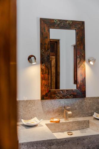 a bathroom with a sink and a mirror at Bali Style Boutique Hotel in Las Terrenas