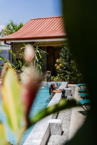 a person in the water in a swimming pool at Bali Style Boutique Hotel in Las Terrenas