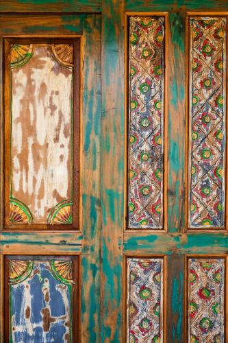 a wooden wall with four stained glass windows at Bali Style Boutique Hotel in Las Terrenas