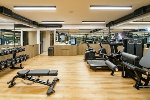 a gym with a lot of treadmills and machines at Rocca a Mare Heraklion - Handwritten Collection in Heraklio Town
