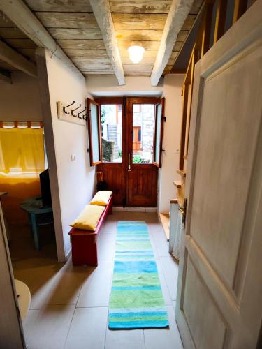 a hallway with a door and a rug on the floor at Apartment Mirjana Cres in Cres