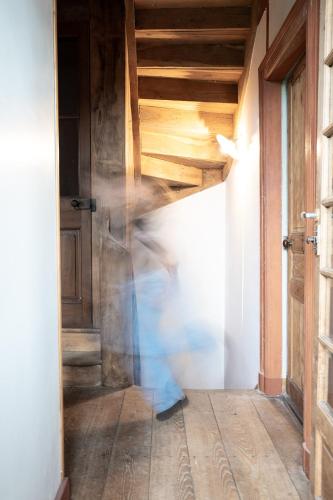 a person running through a hallway with a wooden ceiling at La Glane at Le Maingaud in Saulgond