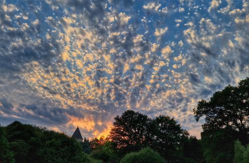 a cloudy sky at sunset with trees in the foreground at La Glane at Le Maingaud in Saulgond