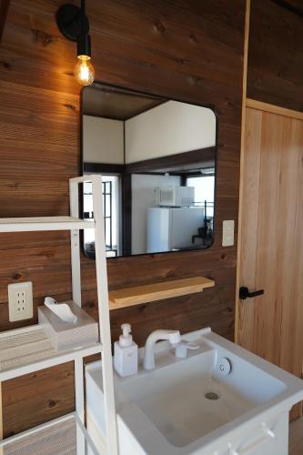 a bathroom with a sink and a mirror at tonema in Tokyo