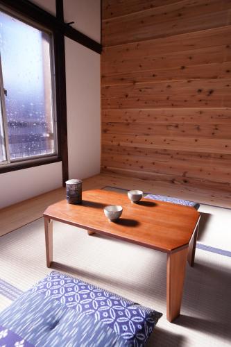 a coffee table in a room with a window at tonema in Tokyo