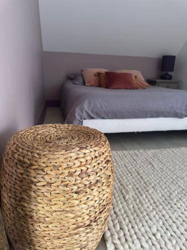 a bedroom with a bed and a rattan table at Détente et charme au Domaine in Coust
