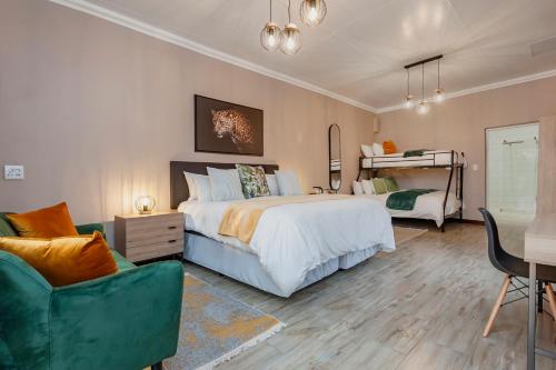 a bedroom with a bed and a chair and a desk at Airport Tower Lodge in Kempton Park