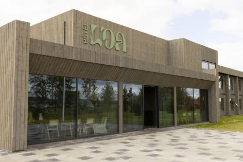 a building with a sign on the side of it at Hotel Loa in Hvolsvöllur