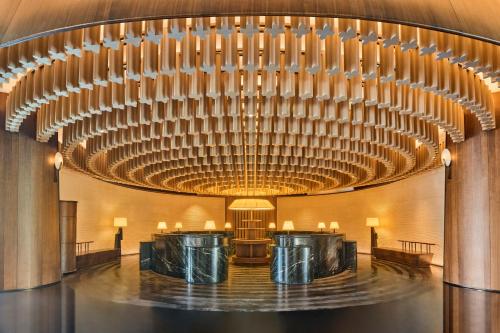 a large lobby with a large chandelier at Shu Hua Hotel Tianmu Mountain, Curio Collection By Hilton in Hangzhou