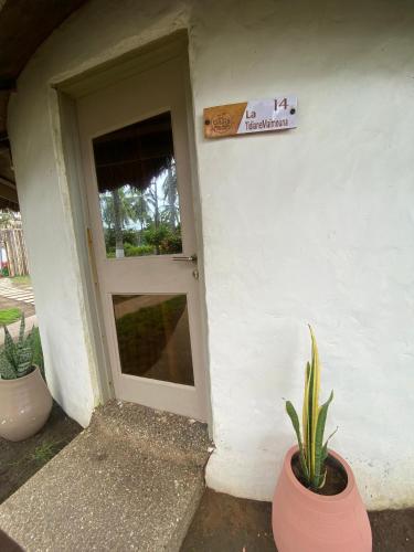 a door to a house with a plant in front of it at Oasis beach resort in Cape Coast