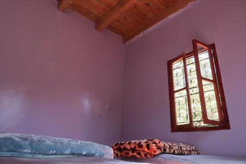 a bedroom with a bed and a window at Gite Megdaz in Megdaz