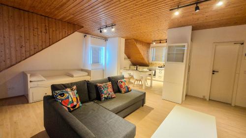 a living room with a couch and a kitchen at Cozy City Apartments 3, 2-Room Flat for Vacation & Messe Düsseldorf, Perfect Connectivity in Ratingen