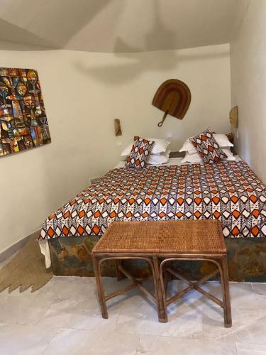 a bedroom with a bed with a table in it at Oasis beach resort in Cape Coast