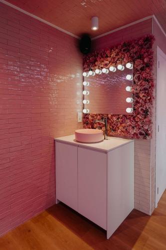 a bathroom with a pink wall with a sink at Designer Hôtel in Heusy