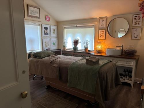 a bedroom with two beds and a mirror and a window at Holdsworth House Hotel in Halifax