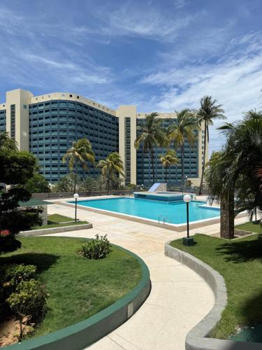 a resort with a swimming pool and a building at Apartamento vista al mar Seaview apartment in Pampatar