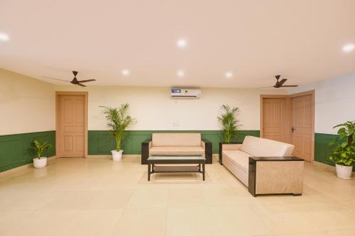 a waiting room with a couch and a chair at White Pepper in Faridabad
