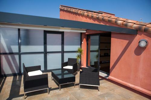 a patio with chairs and tables on a building at Eden Hotel & Spa in Cannes