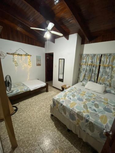 a bedroom with two beds and a ceiling fan at Casa Todah B&B in Liberia