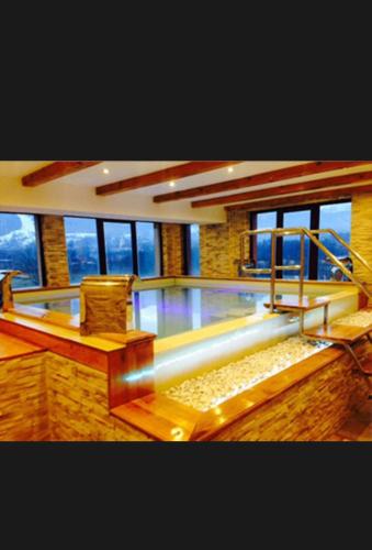a living room with two chairs and a glass floor at Hotel Bran Dracula in Bran