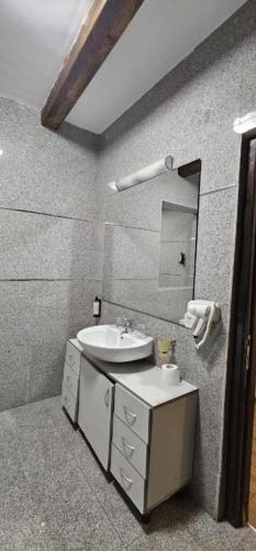 a bathroom with a sink and a mirror at Hotel Bran Dracula in Bran