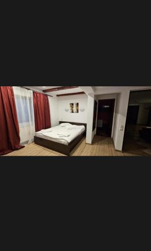 a small bedroom with a bed in a room at Hotel Bran Dracula in Bran