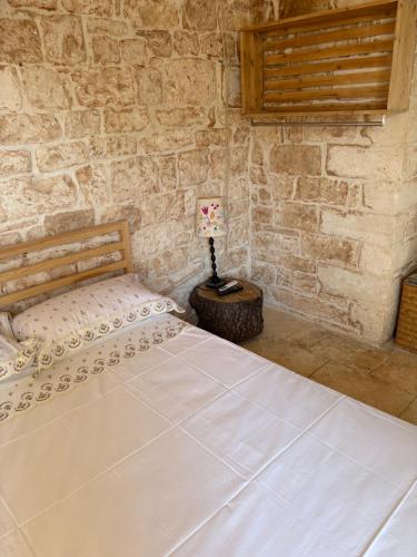 a bedroom with a bed and a table with a lamp at Liuzzi ross in Martina Franca