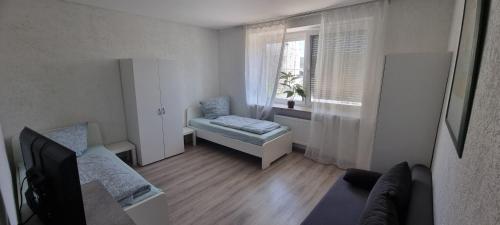 a living room with a couch and a window at Monteurwohnung in Arzberg
