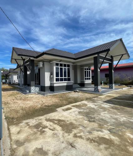 a small house with a large driveway at Eleeya Guest House in Ketereh