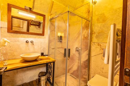 a bathroom with a glass shower and a sink at Walnut House in Goreme