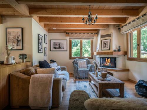 a living room with a couch and a fireplace at Chalet Evelyn - OVO Network in Morzine