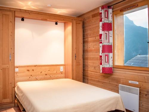 a bedroom with a bed and two windows at Studio cosy à Pra Loup avec balcon et parking - FR-1-504-229 in Uvernet-Fours
