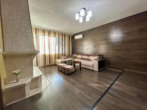 a living room with a couch and a table at Apart House Ana Апартамент за гости Ана in Vratsa