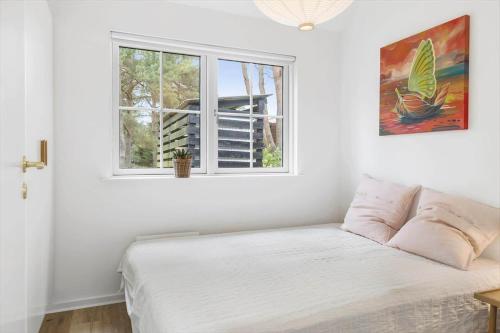 a bedroom with a bed and a window at HA386-Hals-Merkurvej-91 in Hals