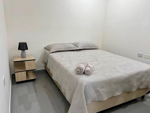 a bedroom with a bed with two slippers on it at Departamento con la mejor vista de Equipetrol SCZ in Hamacas