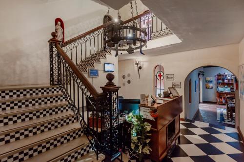 a staircase in a home with a checkered floor at Airport Tower Lodge in Kempton Park