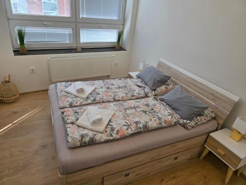 a bed with two pillows on it in a bedroom at Spirit apartments Brno, with parking in Brno