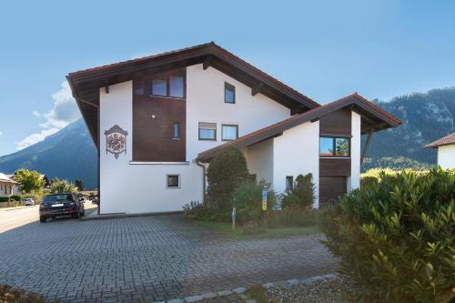 a white house with a brown roof at Ferienwohnung Sophia Inzell - Neu in Inzell
